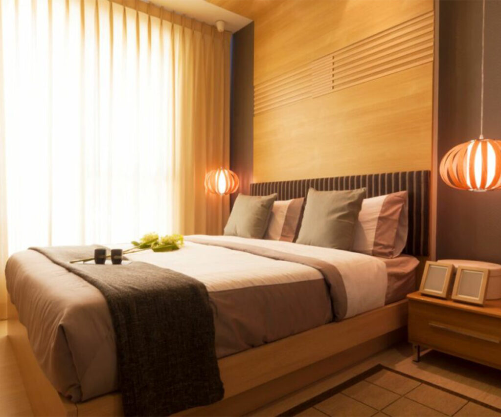 Warm lighting, neutral tones, and natural textures define cozy 2025 bedroom trends.